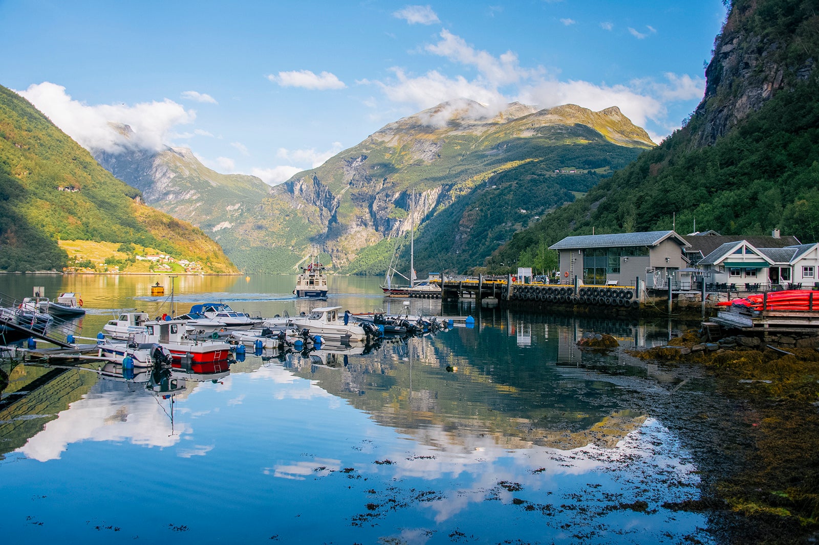 Marina in the norwegian town Geiranger and view of the Geiranger fjord, UNESCO-protected
