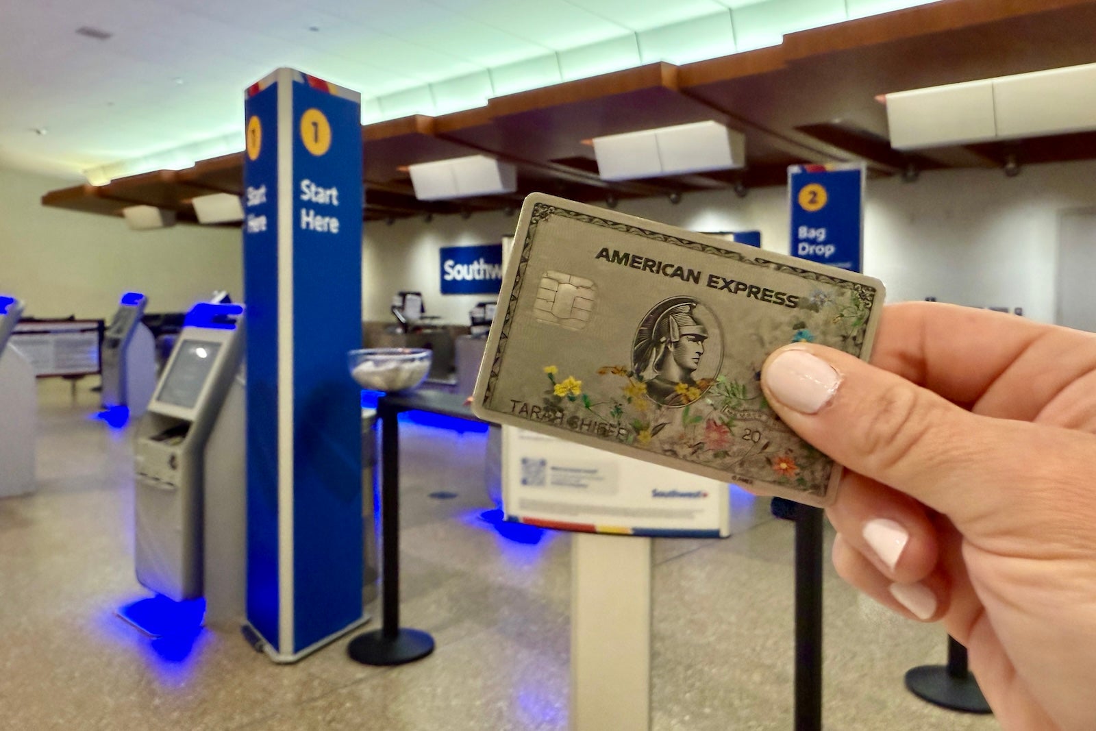woman holding credit card at the airport