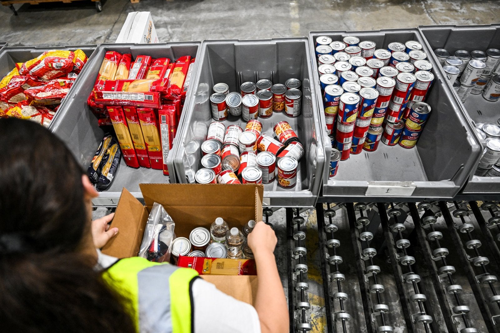 Volunteers assemble relief packages for Hurricane Melissa at the Global Empowerment Mission headquarters in Miami.