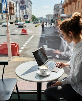 Young woman using laptop in a cafe