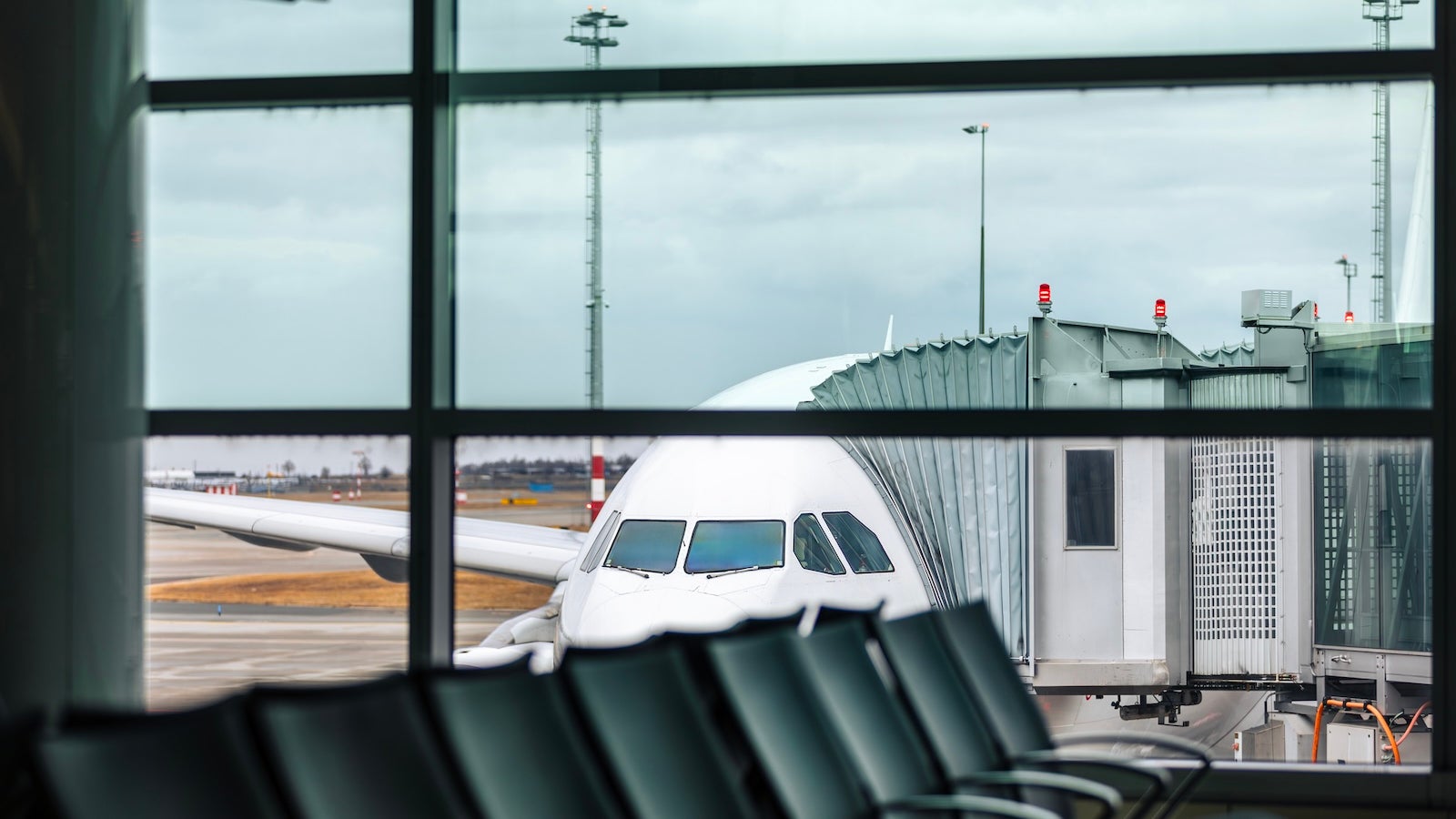 Airplane at gate with passenger boarding bridge