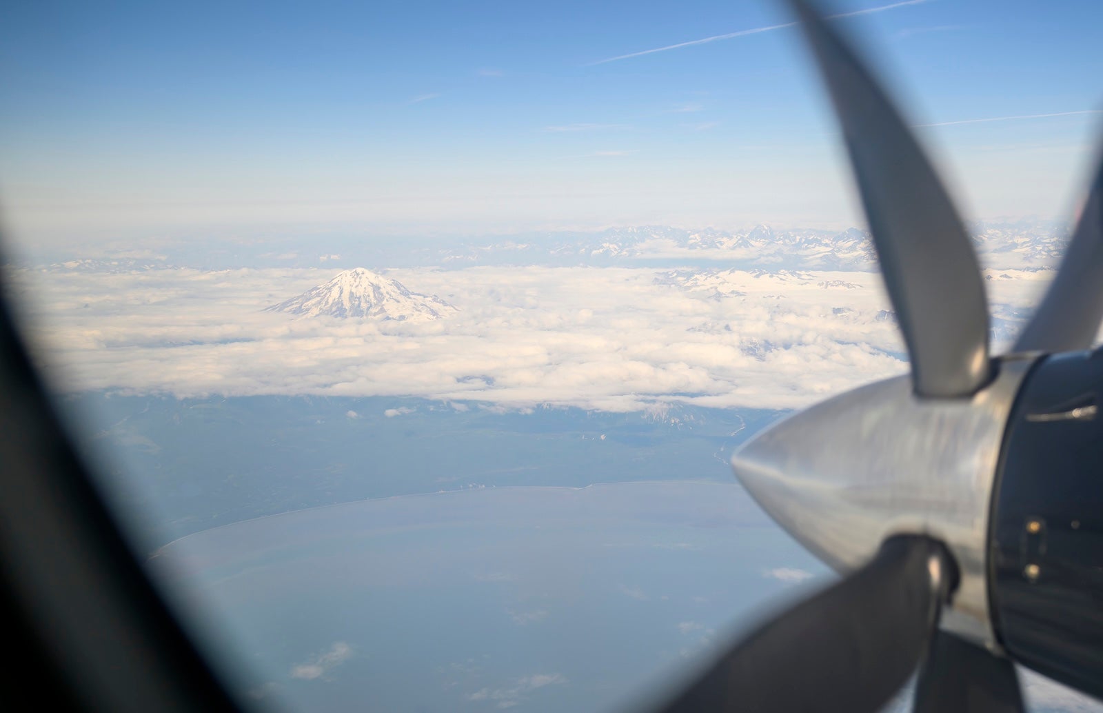 Aerial view of Mount Denali and surrendering mountains from a small aircraft with running propeller. Alaska.