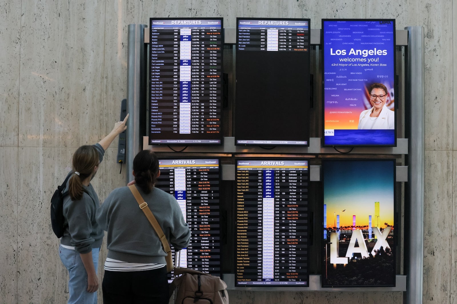 Los Angeles, CA - October 26: Travelers look at the flight information display system at Los Angeles International Airport on Monday, Nov. 3, 2025 in Los Angeles, CA. The Federal Aviation Administration issued a ground delay citing staffing shortages in Southern California's airspace, causing flight delays at LAX.