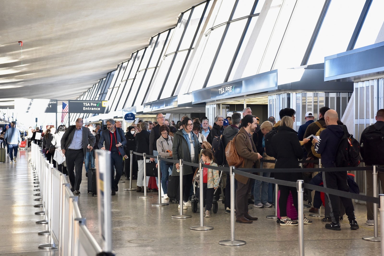 Passengers wait at a TSA checkpoint at Dulles International Airport (IAD). 