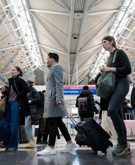 Travelers at the United Airlines check-in area at O'Hare International Airport (ORD)