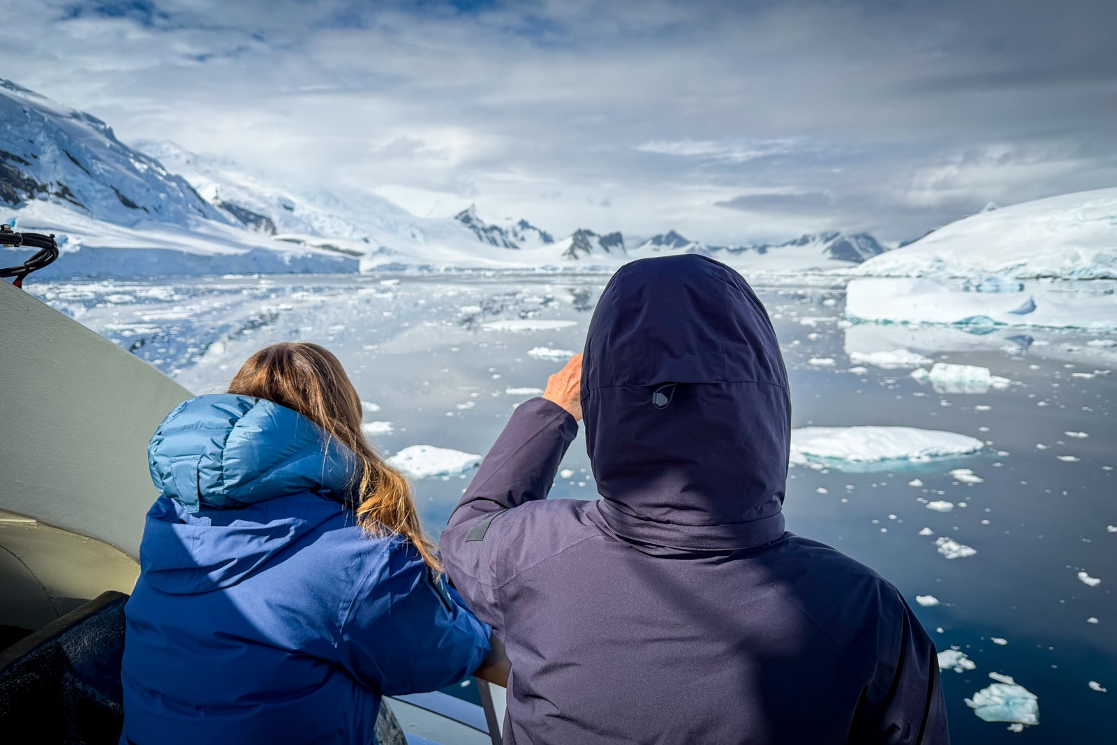 Passengers gaze at the passing scenery from Roald Amundsen's open decks.