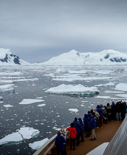 An HX Expeditions ship sails through the icy waters of Antarctica