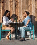 Couple eat a sandwich together.