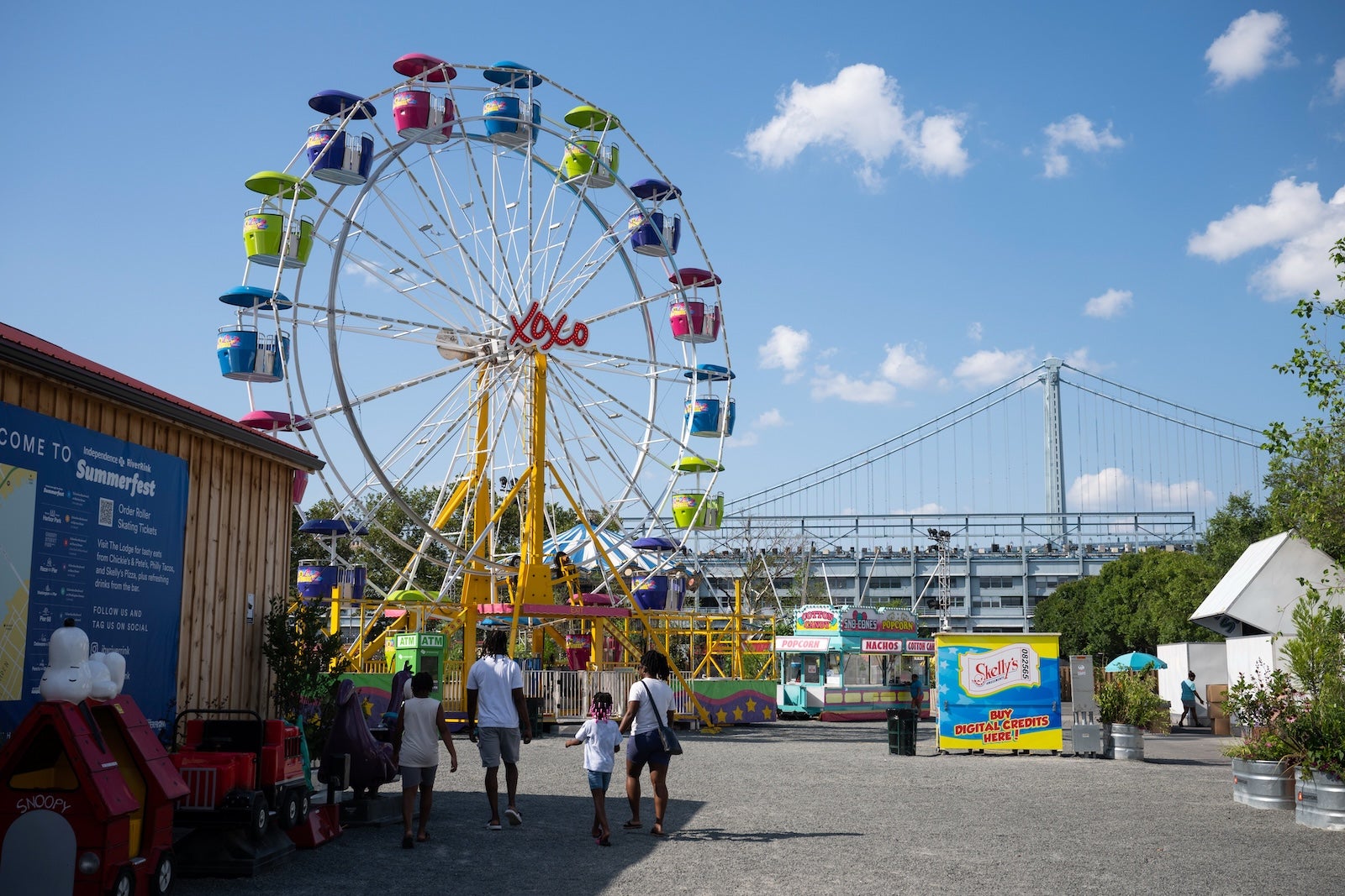 A family enters the Independence Blue Cross RiverRink Summerfest in Philadelphia, Pennsylvania, US, on Monday, July 21, 2025.
