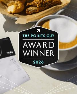 Atmos Rewards Summit card on a table with coffee cup