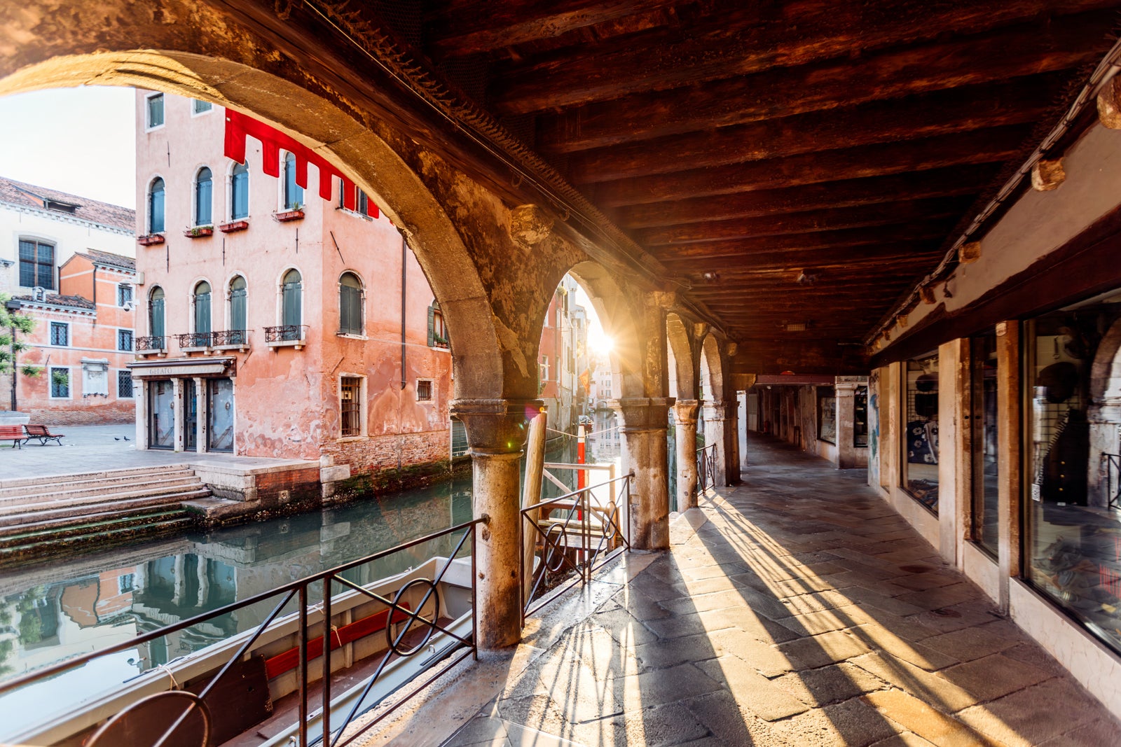 Sun shining through the arches at sunrise in Venice, Italy