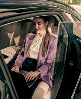 woman on laptop in car