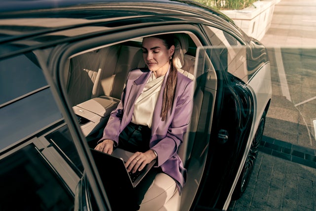 woman on laptop in car
