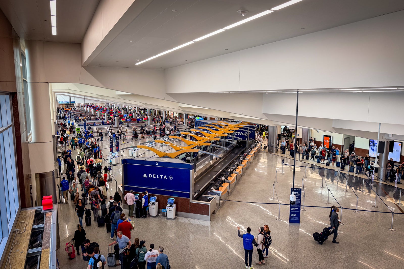 Travelers wait in a security line at Hartsfield-Jackson Atlanta International Airport (ATL).