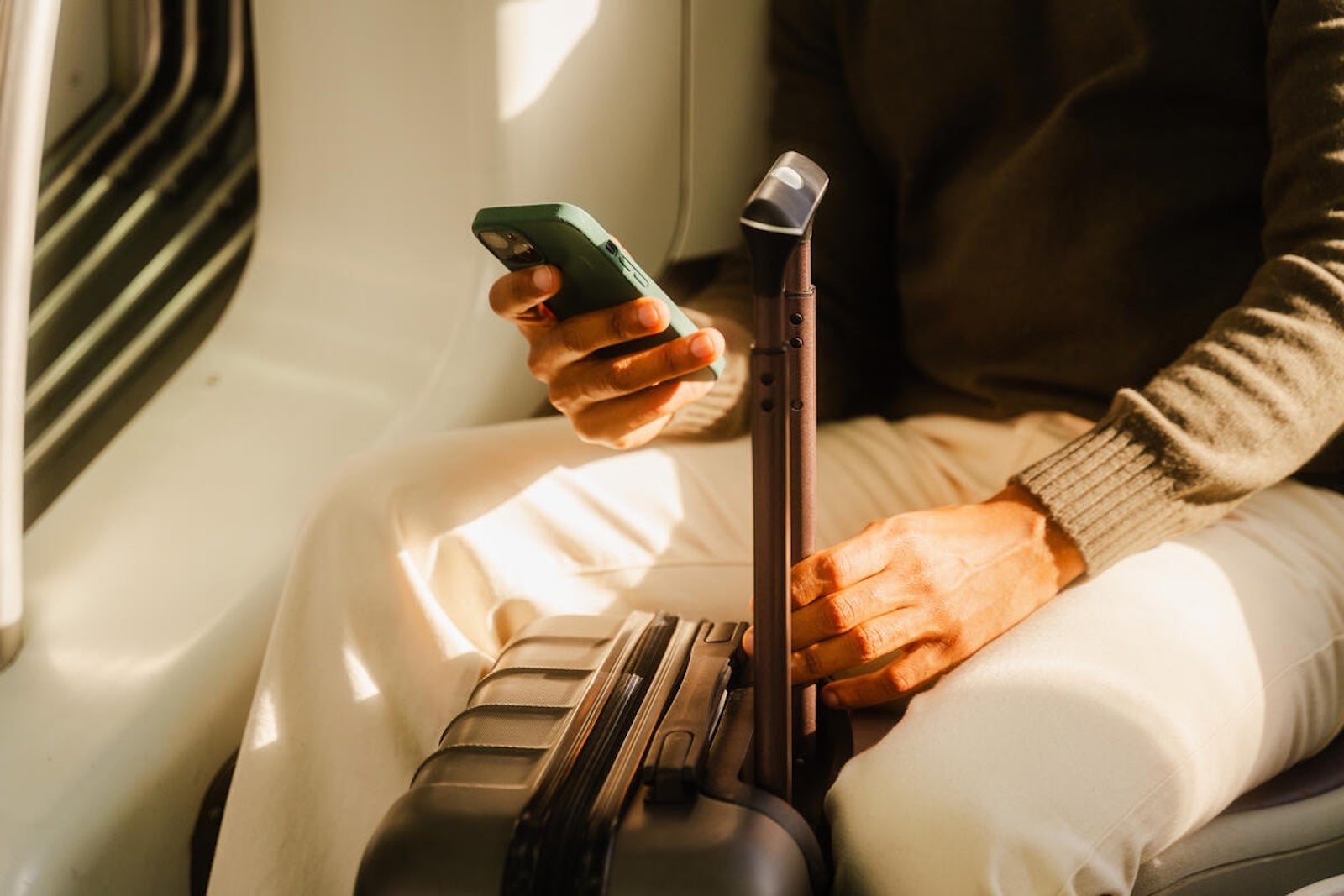Person sitting on the train using a smart phone