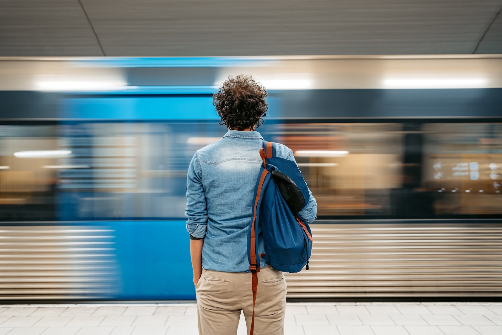 Young man waiting for a subway train in Stockholm, Sweden