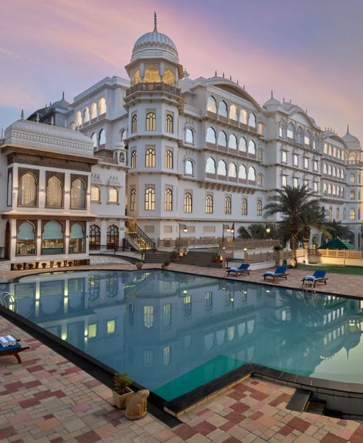 palatial hotel with pool at sunset