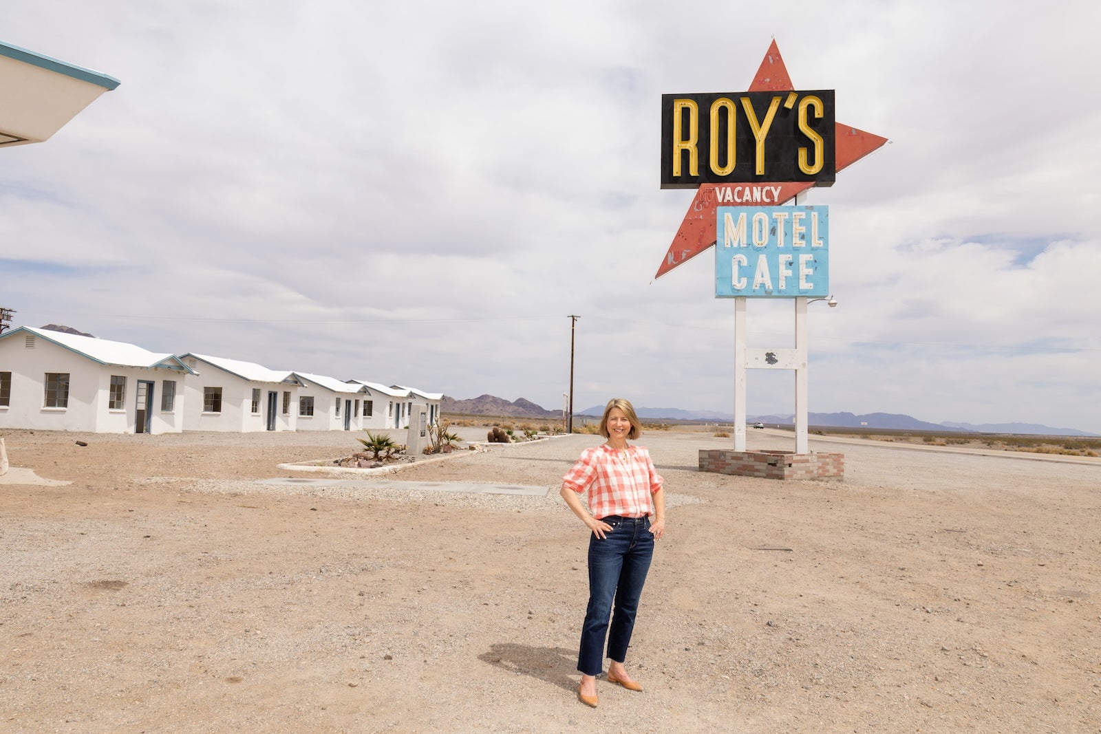 woman standing outside of a cafe