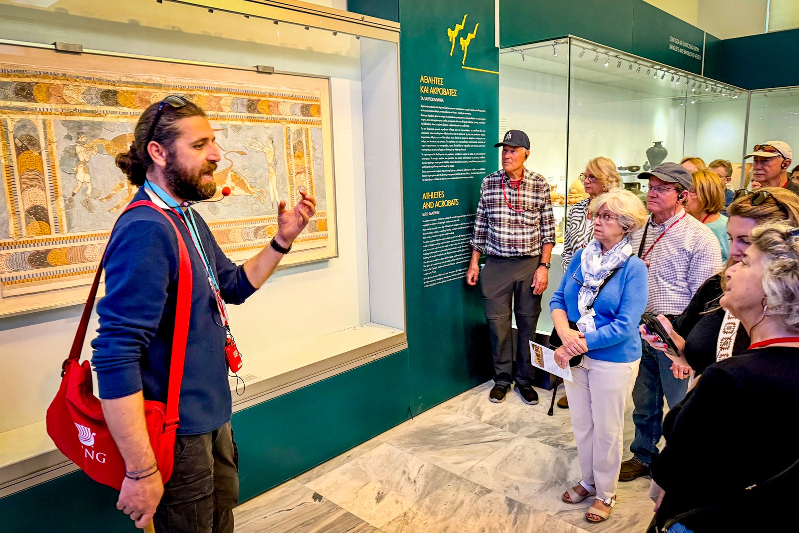 A guide explains Minoan artifacts to Viking passengers during a visit to the Heraklion Archeological Museum.
