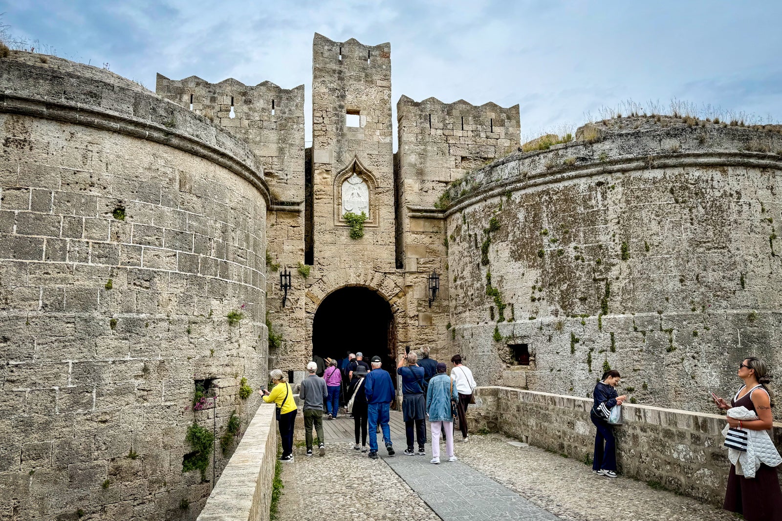 Viking passengers pass under one of the main gates to Rhodes during a walking tour.