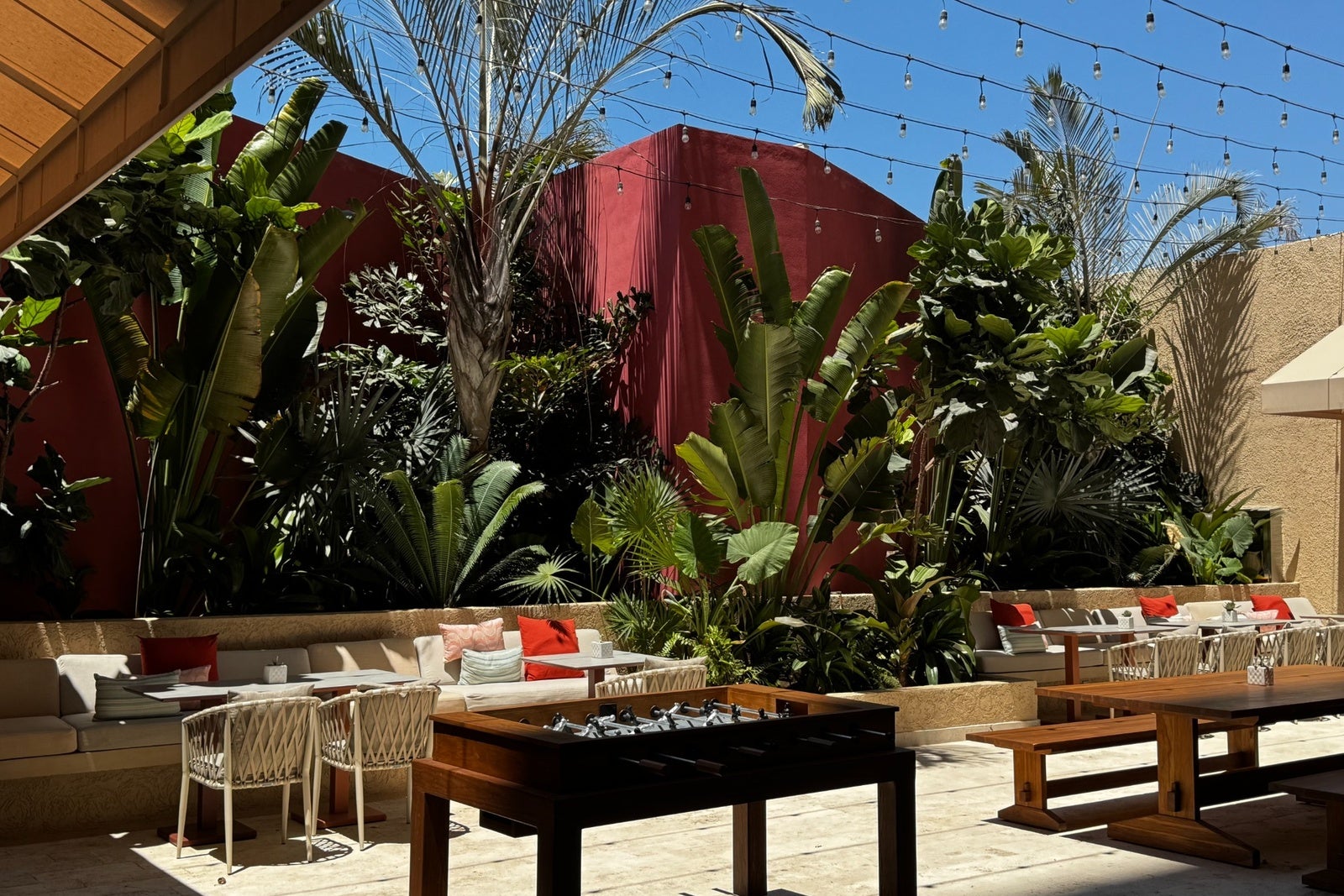 Exterior lounge space with hanging lights, plants and games at Westin Playa Vallarta