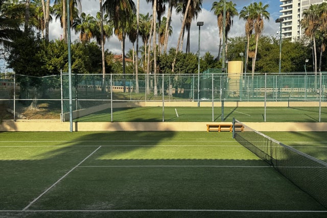 Green tennis courts with palm trees at Westin Playa Vallarta