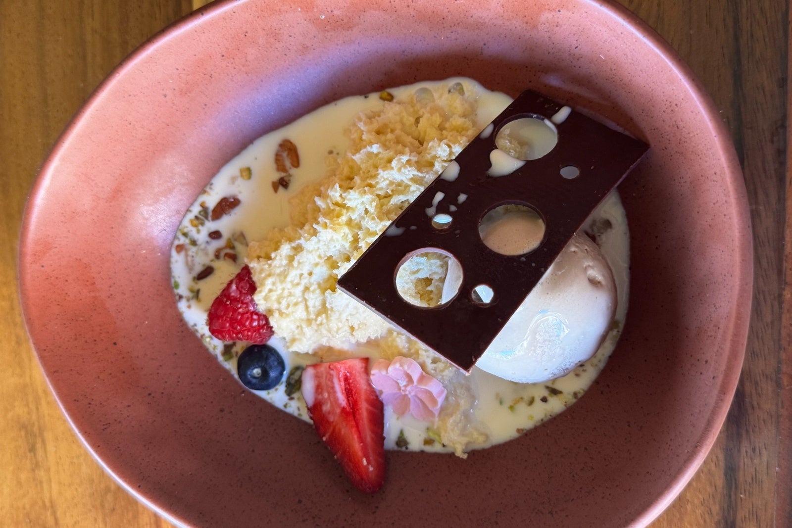 Tres leches with chocolate and ice cream on a pink plate