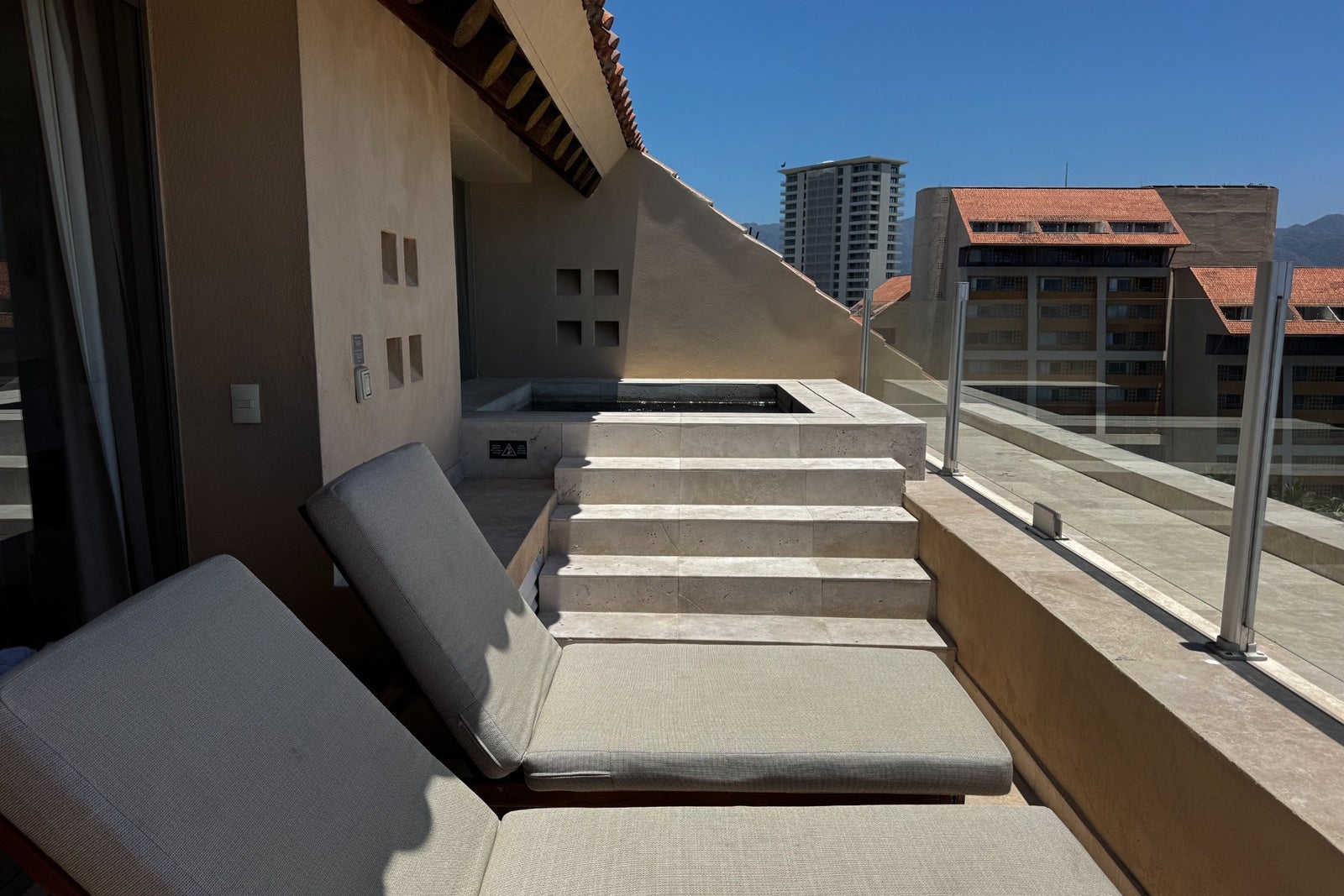Balcony with lounge chairs and plunge pool