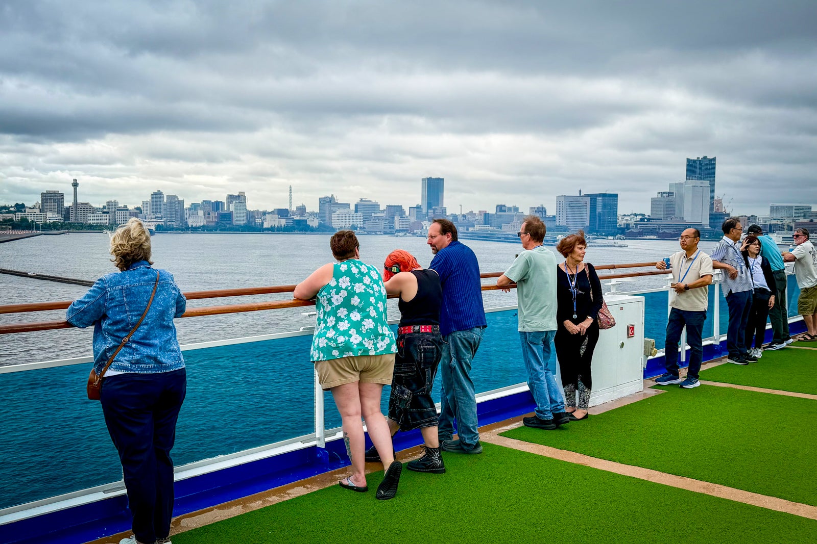 Passengers gaze upon downtown Yokohama as Diamond Princess sails for Nagasaki.
