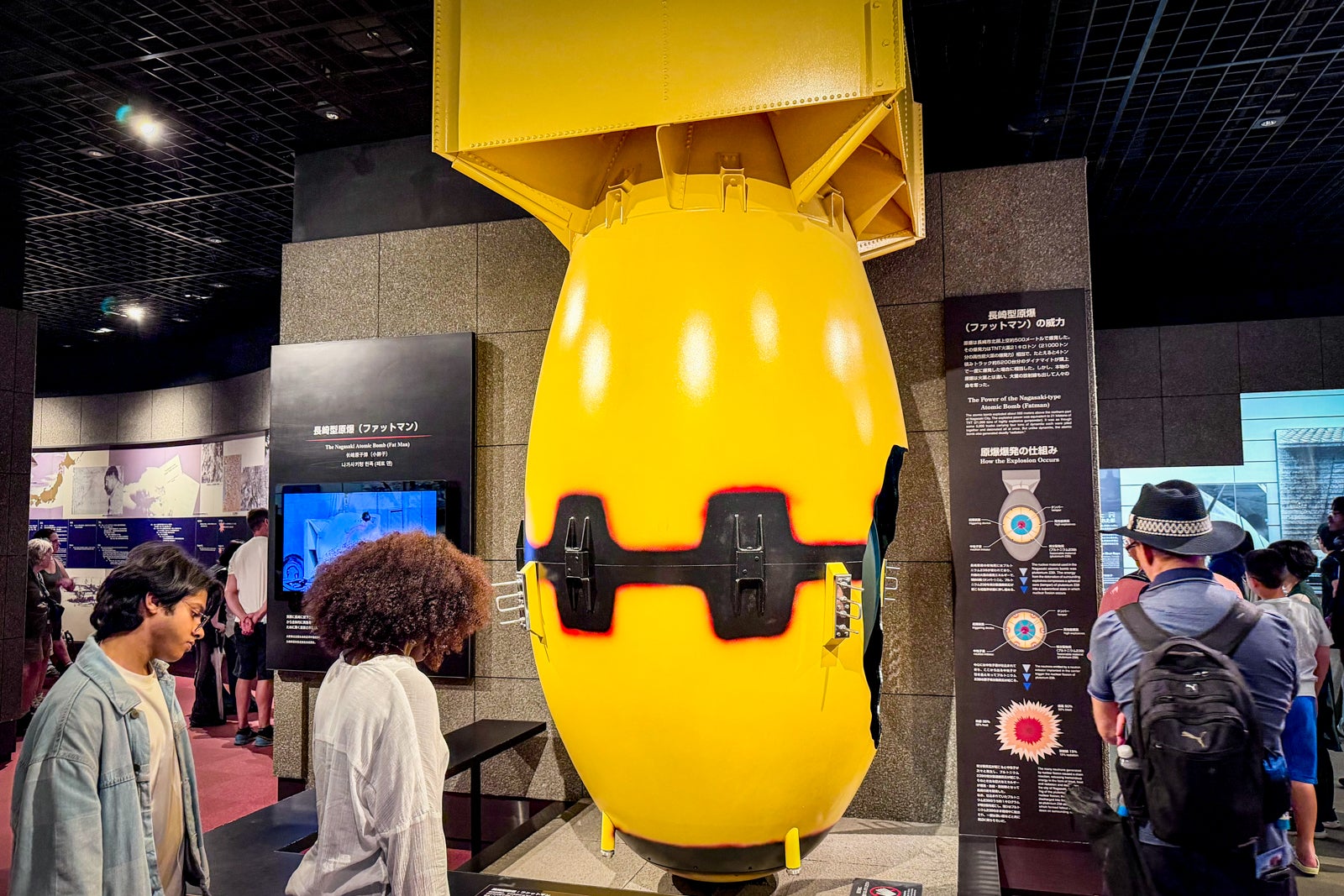 A full-size replica of the "fat boy" atomic bomb dropped on Nagasaki gives visitors a sense of its scale.