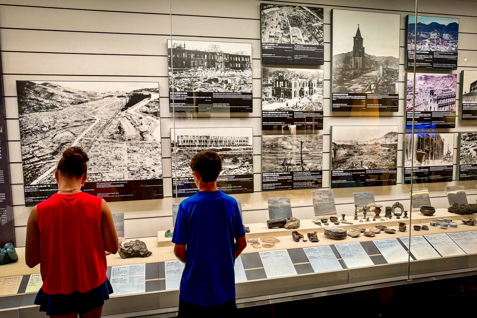 Visitors look at photographs showing the aftermath of the atomic bombing of Nagasaki.