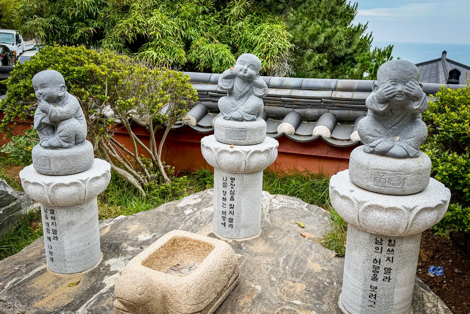 Stone sculptures at the Buddhist wish lanterns and wish papers left by visitors to the A large smiling buddha is among the attractions at the Haedong Yonggungsa Temple.