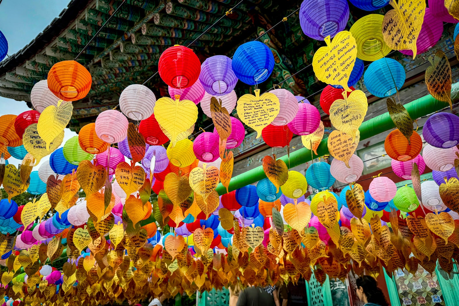 Buddhist wish lanterns and wish papers left by visitors to the A large smiling buddha is among the attractions at the Haedong Yonggungsa Temple.