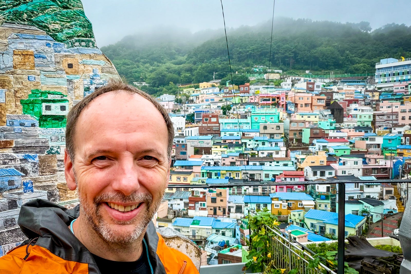 TPG's Gene Sloan poses for a photo at the colorful Busan neighborhood known as the Gamcheon Culture Village.
