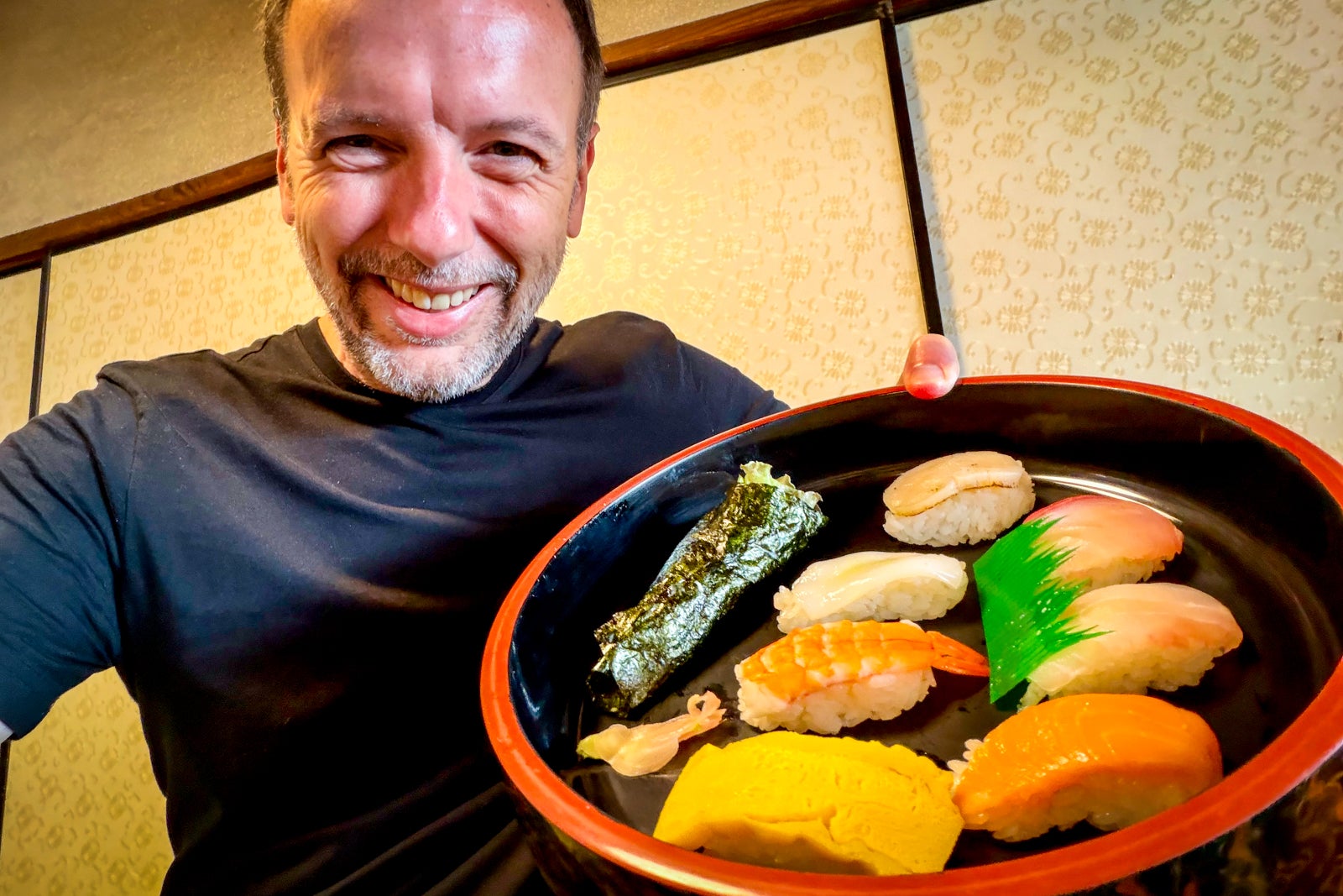 TPG's Gene Sloan shows off sushi shows off the results of a sushi-making class.
