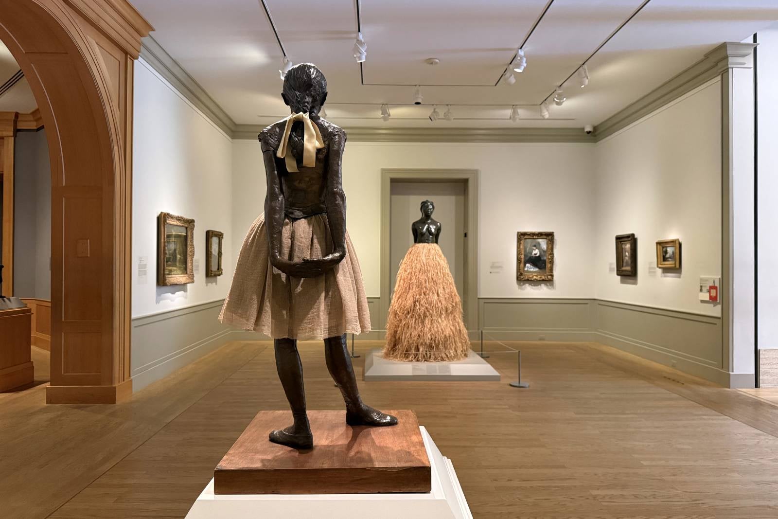 Two statues facing each other inside museum