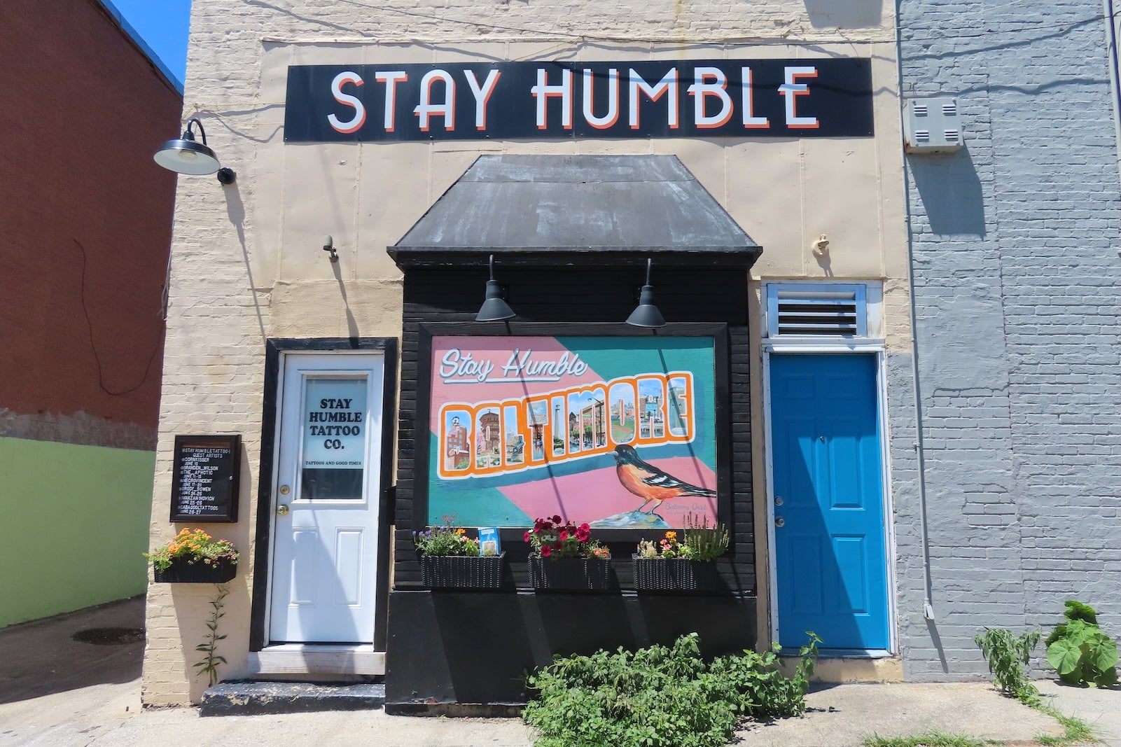 shop exterior with sign that says "Stay Humble Baltimore"