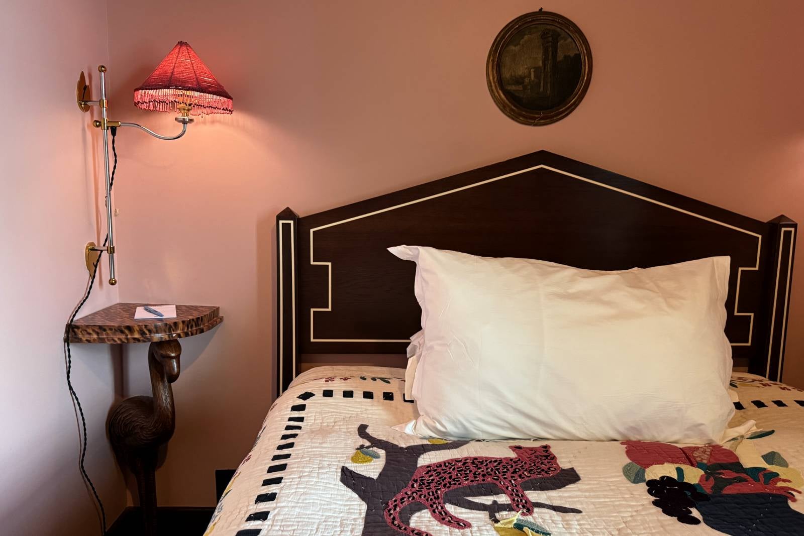 Detail of bed and side table in a hotel room