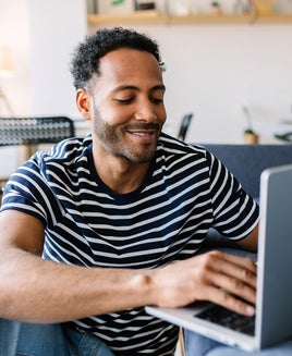 Man uses a laptop at home