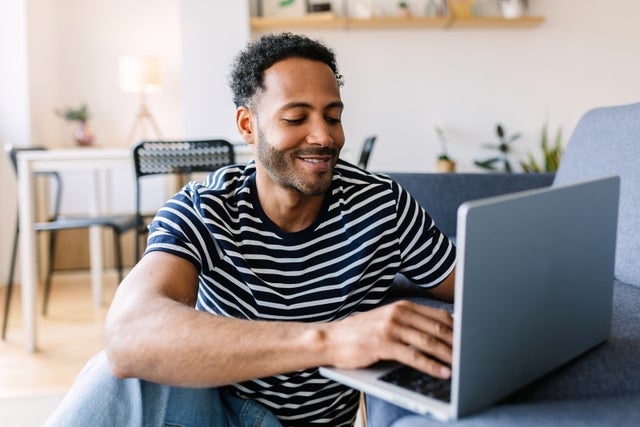 Man uses a laptop at home