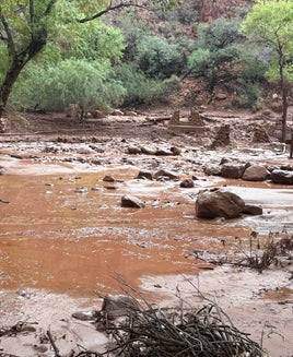 Remnants of stone bridge pylons remain along Bright Angel Creek following a flash flood that destroyed the footbridge on August 29. The flooding caused significant damage to infrastructure throughout the canyon.