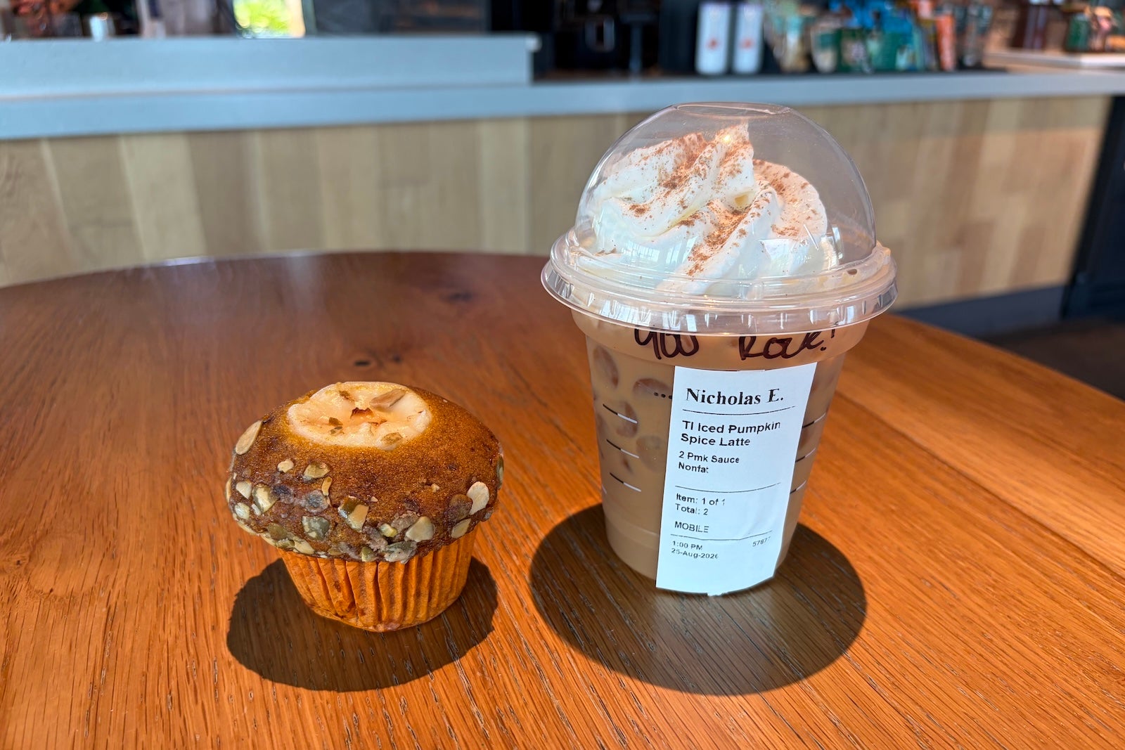 An iced pumpkin spice late and pumpkin cream cheese muffin at Starbucks