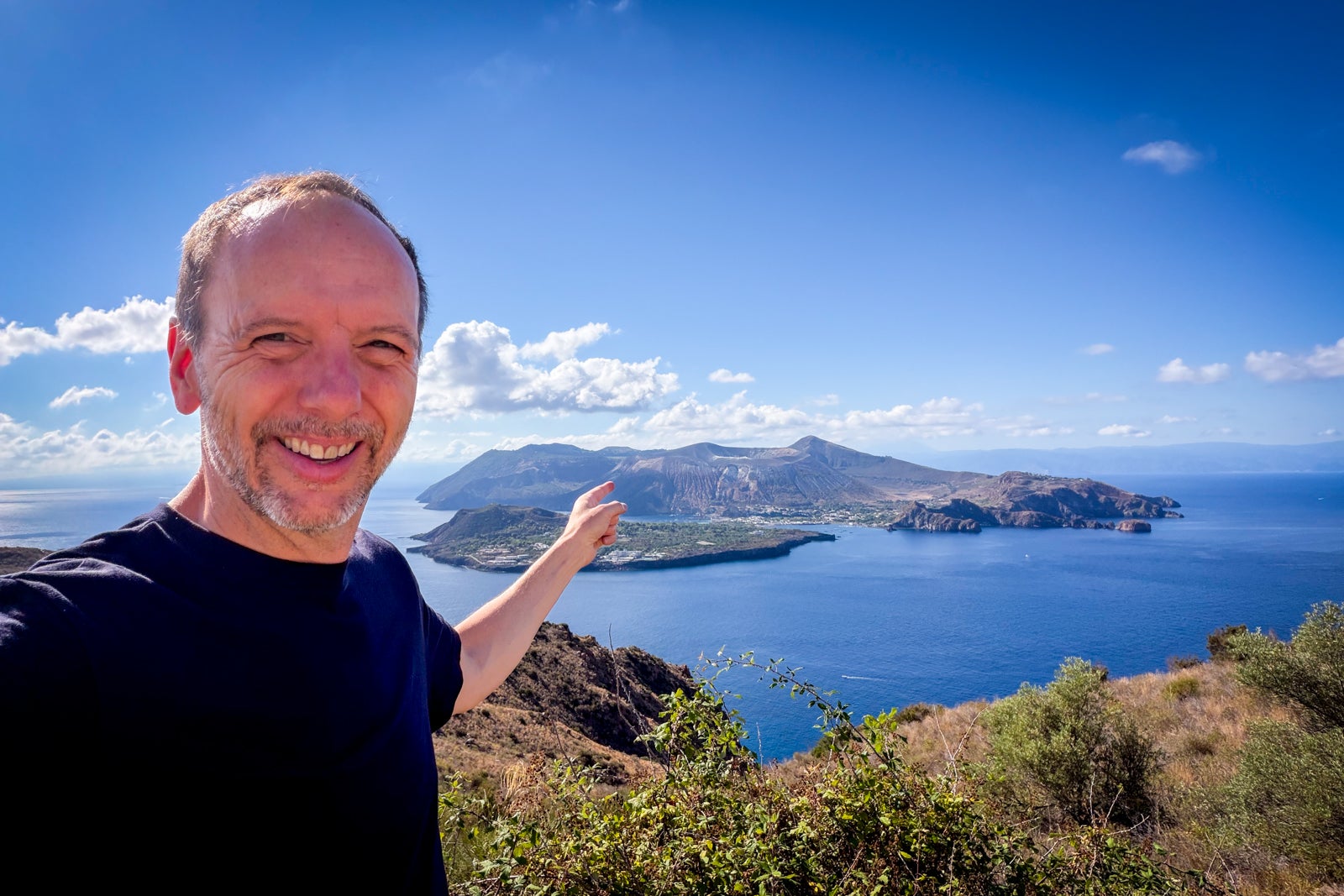 TPG's Gene Sloan pointing to smoking Volcano Island, which is just off Lipari
