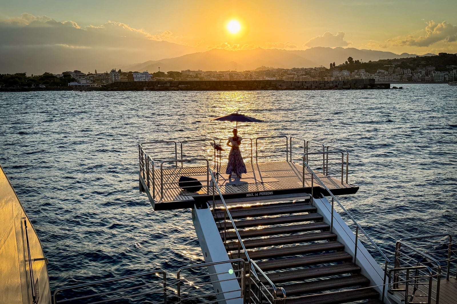 A singer performs from the marina platform on Le Dumont d'Urville.