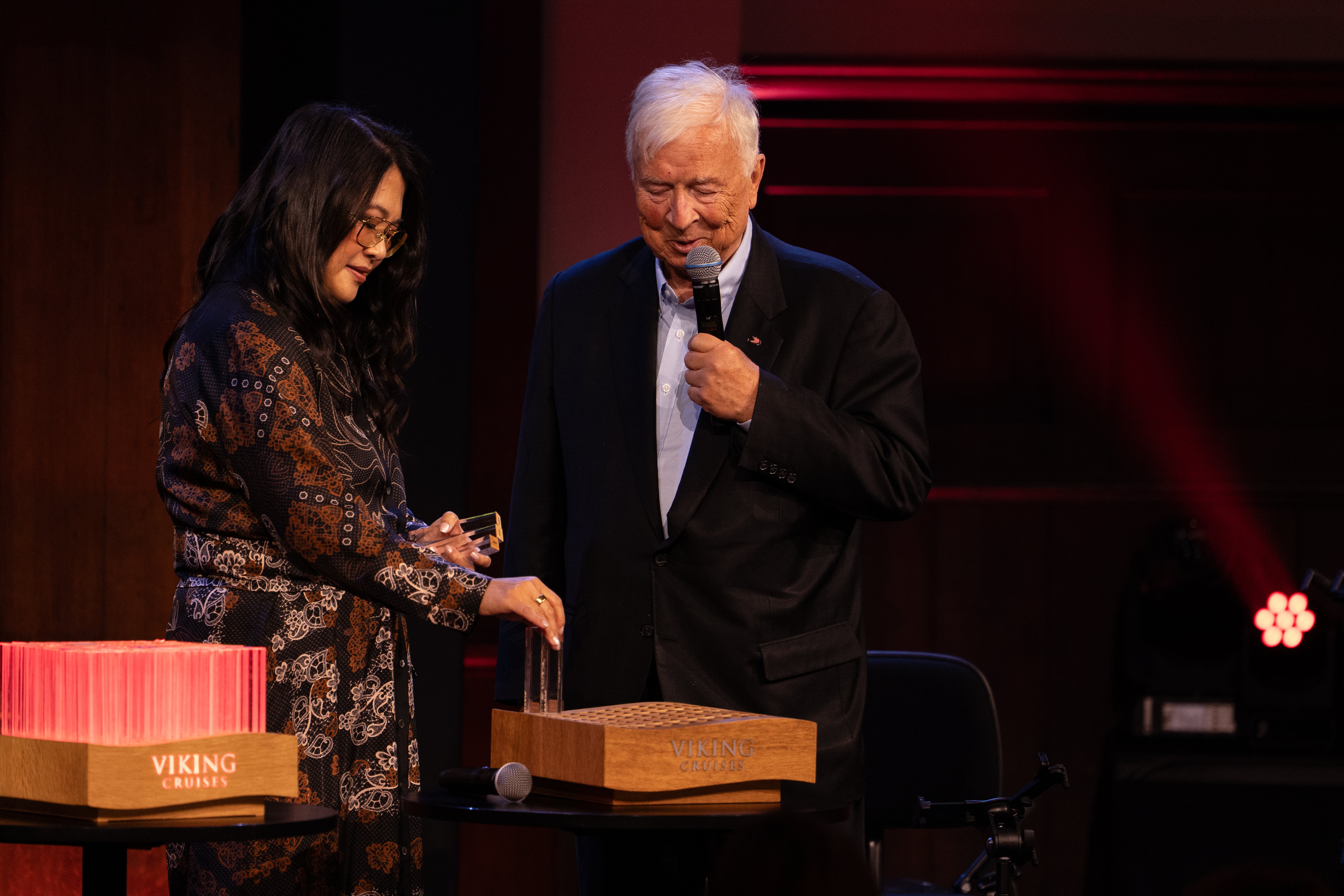 Viking founder Torstein Hagen and CEO Leah Talactac with a display showing rods that represent each river ship added to the Viking fleet.