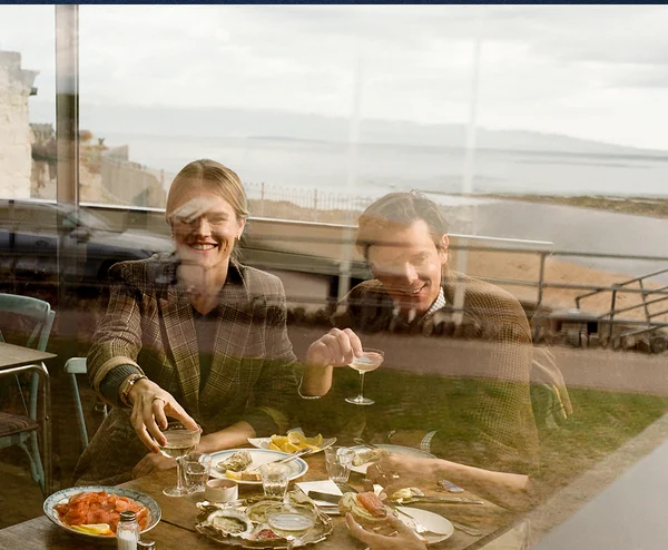 Diners sharing oysters and wine on ice